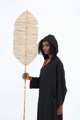 Model wearing Atelier Loreen’s Black Label handmade hooded garment, crafted from luxurious materials in a female led Dubai atelier. A timeless piece radiating elegance and sophistication.